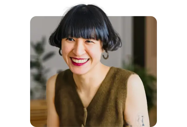 hp 6 happy young asian woman with red lipstick and tattoos smiling.webp